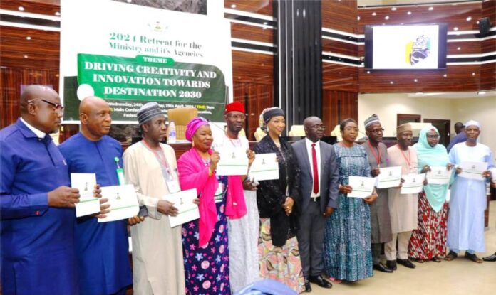 HON.MINISTER FMACCE HANNATU MUSA MUSAWA, PERM. SEC. JAMES SULE AND THE DIRECTORS OF THE MINISTRY AFTER SIGNING THE PERFORMANCE BOND.