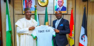 The Honourable Minister of Interior, Hon. (Dr.) Olubunmi Tunji-Ojo (R) receiving a customized jersey from the President, NFF, Alhaji Ibrahim Musa Gusau.(L).