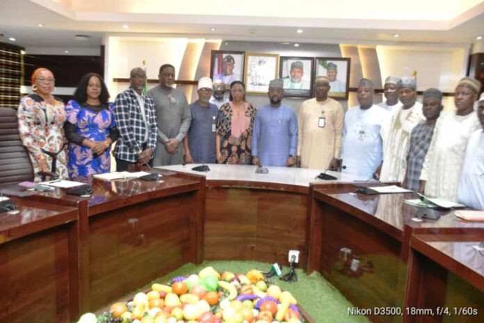 The Permanent Secretary, FMAFS, Mr Temitope Fashedemi (C), and Members of the Committee during the inauguration ceremony.