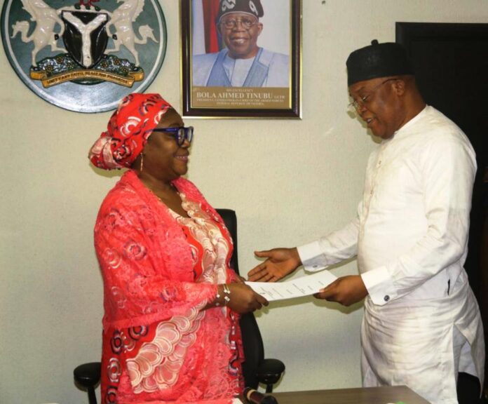 Perm Sec EPO, Dr. Aishetu Gogo Ndayako Mohammed receiving Handover- Notes from the Director, Pollution Control, Mr Clinton Igwe