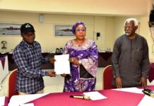 Head of the Civil Service of the Federation, Mrs Didi Esther Walson-Jack, OON,mni( middle), presenting a copy of the signed Memoranda of Understanding(MOU) on Consequential Adjustments in Salaries to the National Chairman,JNPSNC Comrade Benjamin Anthony(L), while the Chairman, National Salaries, Incomes and Wages Commission, Mr Ekpo Nta(R), looks on.