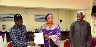 Head of the Civil Service of the Federation, Mrs Didi Esther Walson-Jack, OON,mni( middle), presenting a copy of the signed Memoranda of Understanding(MOU) on Consequential Adjustments in Salaries to the National Chairman,JNPSNC Comrade Benjamin Anthony(L), while the Chairman, National Salaries, Incomes and Wages Commission, Mr Ekpo Nta(R), looks on.