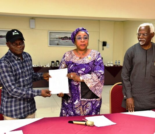 Head of the Civil Service of the Federation, Mrs Didi Esther Walson-Jack, OON,mni( middle), presenting a copy of the signed Memoranda of Understanding(MOU) on Consequential Adjustments in Salaries to the National Chairman,JNPSNC Comrade Benjamin Anthony(L), while the Chairman, National Salaries, Incomes and Wages Commission, Mr Ekpo Nta(R), looks on.