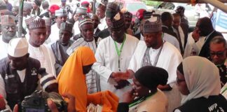 3rd left, Executive Governor of Katsina State, His Excellency Dr Dikko Umaru Radda, 2nd left, Permanent Secretary Federal Ministry of Humanitarian Affairs and Poverty Alleviation Abel Enitan, 1st left, National Coordinator National Social Investment Programme Agency, Prof Badamasi Lawal Charanchi, 4th left, Representative of World Food Programme, Manuela Reinfeld, Nigeria's Permanent Mission to ECOWAS, H.E Amb. Nuhu Musa, Representative of ECOWAS COMMISSION, Alozie Amaechi Godfrey and other dignitaries presenting cash-based Transfer Voucher to a person with disability beneficiary during the launch of the Phase 2 ECOWAS-FMHAPA Stabilisation Project held on Friday, 30th August, 2024 at Government House Katsina State