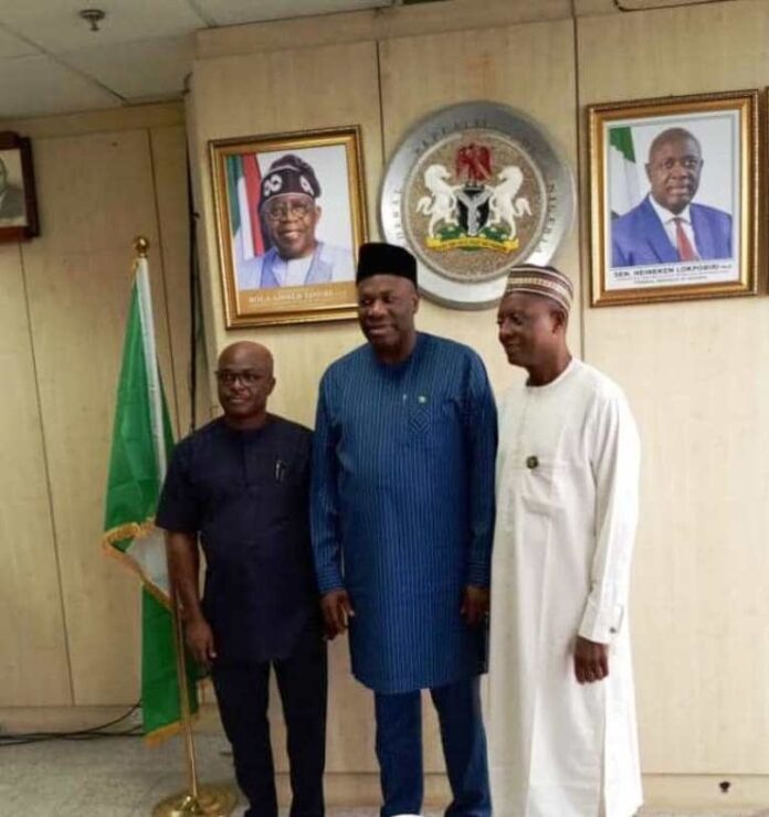 The Permanent Secretary MPR, Amb. Nicholas Agbo Ella (centre) flanked by the Chairman of NGEP, Prof. Mohammed Ibrahim (right) and Director (Planning, Research and Statistics) NDE Mr. Onwuliri Edmund in a group photograph at the inauguration ceremony.