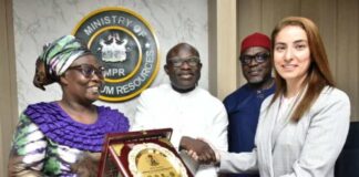 The representative of the Permanent Secretary MPR, Engr. Kamoru Busari FNSE (centre) being assisted by the Director, Gas Department, Mrs. Oluremi Komolafe (left) while presenting a souvenir to the Head of Sustainability Investments, Dr. Miray Zaki during the meeting.