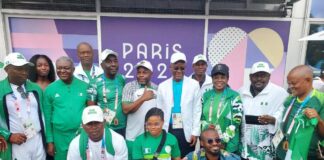 The minister of sports Development , Sen John owan Enoh and the winning Paralympic Team in Paris