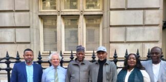 Hon Minister of State, Housing and Urban Development, Abdullahi Tijjani Gwarzo in a group photograph with Jeremy Moody, Secretary and Adviser CAAV and other officials of the Ministry during the meeting