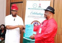 Director General, Committee on Youth Moblization and Sensitization, Obinna Nwaka (l), presents proposal collaboration with Federal Ministry of Special Duties and Inter-governmental Affairs to Director, Policy Implementation and Monitoring of Government Decisions, Dr. Cyprian Kpakol, rep. of the PS.