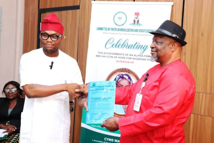 Director General, Committee on Youth Moblization and Sensitization, Obinna Nwaka (l), presents proposal collaboration with Federal Ministry of Special Duties and Inter-governmental Affairs to Director, Policy Implementation and Monitoring of Government Decisions, Dr. Cyprian Kpakol, rep. of the PS.