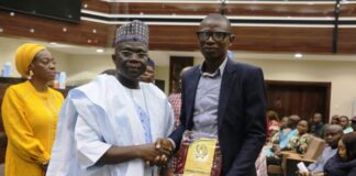 Permanent Secretary, Mr. James Sule; and (Awardee)Tola Adegbola during the historic 2024 Civil Service Reward and Recognition event for thirteen (13) officers organized by the Ministry to celebrate its staff at the Education’s Conference Hall, Federal Secretariat, Phase 3, Abuja.