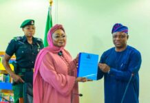 Honourable Minister of Women Affairs, Hajiya Imaan Sulaiman-Ibrahim, fsi, receiving the Hand-Over Notes from Ambassador Gabriel Aduda, the Ministry's Permanent Secretary today, in Abuja