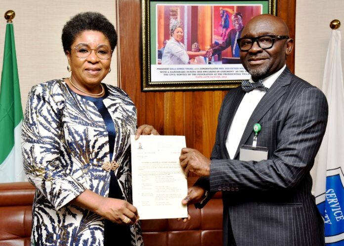 R-L: Mr Alfred Agaba Abah presenting his Letter of Appointment as SSAP to the Head of the Civil Service of the Federation, Mrs Didi Esther Walson-Jack, OON, mni.