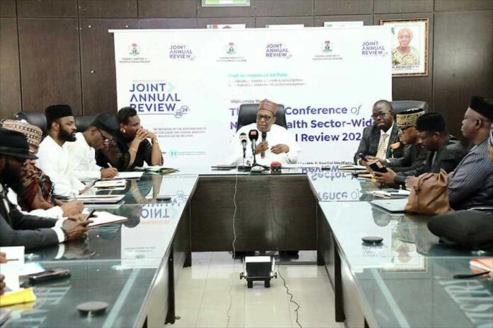 Ministerial Press Briefing on Forthcoming Joint Annual Review JAR meeting: Prof Muhammad Ali Pate Coordinating Minister for Health & Social Welfare addressing Journalists during the Briefing session held 6th Floor Conference Room @ the FMoH & SW Headquarters Office, Abuja: On his right is Dr Olubunmi Aribeana Director Food & Drugs Department, representing Permanent Secretary; On his Left; Dr. Kamil Shoretire, Director Health Planning Research & Statistics Department.