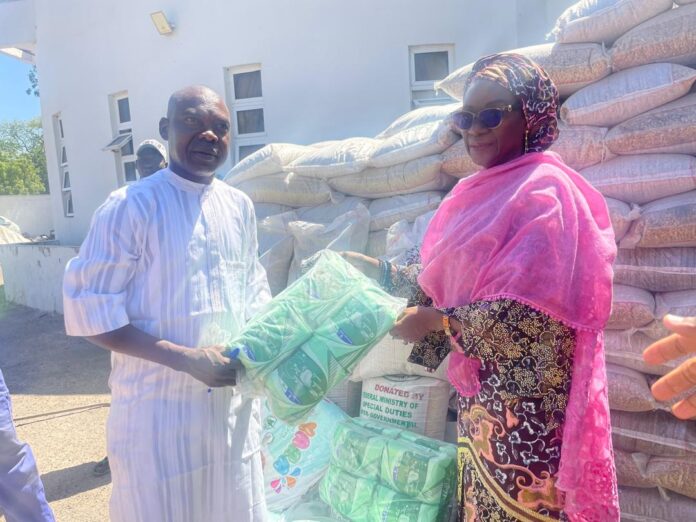 The Permanent Secretary, Dr. Maryam Ismaila Keshinro, handing over the relief materials to the representative of the Borno State Government.