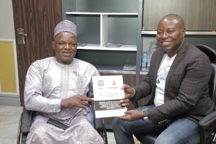 The Executive Secretary, National Commission for Persons with disabilities, Chief Ayuba Gufwan with the CEO Suntech Sunny Okachukwu.