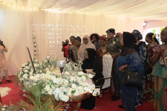 Honourable Minister of Women Affairs, Hajiya Imaan Sulaiman-Ibrahim, signing the Register when she led a delegation of Women Groups on Condolence Visit to the Wife of the Late Chief of Army Staff, Mrs. Mariya Abiodun Lagbaja. To her right is the D-G, MBNWDC, Dr. Asabe Bashir, Director, Women Development, Mrs. Friya Bulus and Director, Economic Services, Mrs. Blessing Anunike