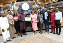 Head of the Civil Service of the Federation, Mrs. Didi Esther Walson-Jack, OON, mni, pose with the symbolic certificate of the Online Compendium of Circulars with members of the technical team.