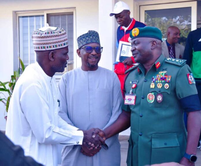 Chairman, National Sports Commission, Mallam Shehu Dikko (middle) flanked to his left by the Chief of Defence Staff, General Christopher Gwabin Musa and to his right by Alhaji Salihu Abubakar during the CDS visit to the Chairman in his office on Wednesday, 23th Nov. 2024.