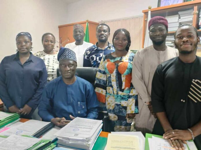 Acting Director General, Bureau of Public Procurement , Barr. Olusegun Omotola seated , around him are the just concluded NYSC members who served in the Bureau. The Ag DG hosted them November, 1 , 2024.