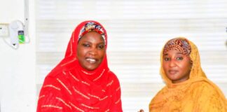 Honourable Minister of State for Education Dr Suwaiba Said Ahmad (R) receiving a presentation from the Deputy National Women leader (APC) 12/12/24