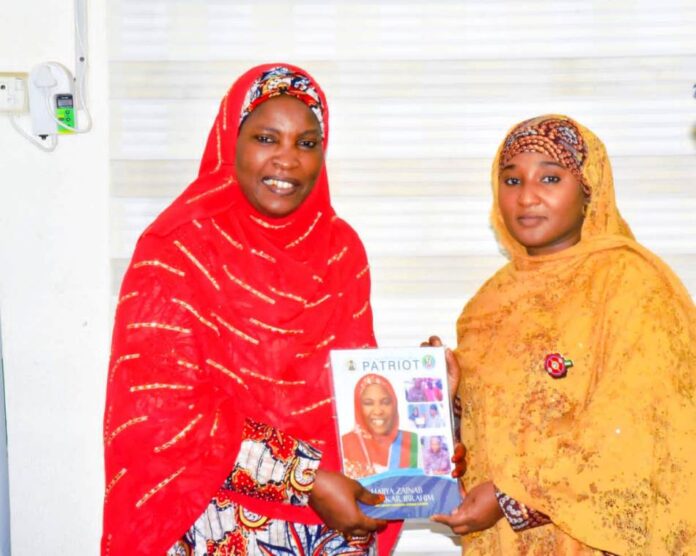 Honourable Minister of State for Education Dr Suwaiba Said Ahmad (R) receiving a presentation from the Deputy National Women leader (APC) 12/12/24