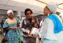 National President, Defence Police Officers Wives Association (DEPOWA), Mrs Oghogho Musa, receiving paliatives from the Honourable Minister of Women Affairs, Hajia Imaan Sulaiman-Ibrahim, on behalf of the Group