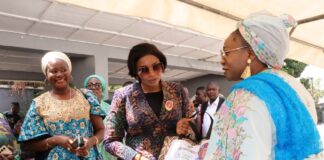 National President, Defence Police Officers Wives Association (DEPOWA), Mrs Oghogho Musa, receiving paliatives from the Honourable Minister of Women Affairs, Hajia Imaan Sulaiman-Ibrahim, on behalf of the Group