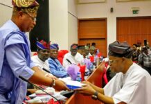 The Honourable Minister of Marine and Blue Economy, Adegboyega Oyetola CON, (r) presents the budget of the Ministry and its Agencies to the Chairman, Senate Committee on Marine Transport, Senator Wasiu Eshinlokun (l).