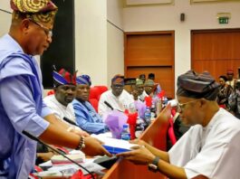 The Honourable Minister of Marine and Blue Economy, Adegboyega Oyetola CON, (r) presents the budget of the Ministry and its Agencies to the Chairman, Senate Committee on Marine Transport, Senator Wasiu Eshinlokun (l).