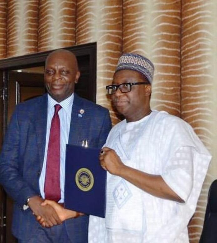 L-R: Chairman RMAFC, Dr. M.B. Shehu OFR; Vice Chancellor, Igbinedion University Okada, Prof. Lawrence Ikechukwu Ezemonye