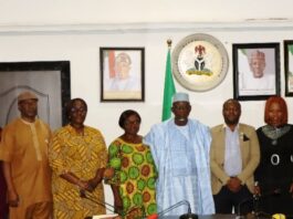 Minister of Labour and Employment, Dr Muhammad Maigari Dingyadi (6th right); Director, Overseeing the Office of the Permanent Secretary, Lauretta Adogu (6th left); Head, Coalition of NGOs (part of the United Nations NGO Committee on Social Development), Daniel Black (5th right); Directors of the Ministry and other members of the coalition during their visit to the Minister, Abuja