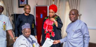 L-R: Executive Secretary NCPWD, Hon. Ayuba Gufwan presenting an appreciation letter to Governor Alex Otti (R) while Her Excellency Mrs Priscillia Otti (M) and Mr David Anyaele, Chairman Commission for the Welfare of the Disabled Persons (behind) looks on