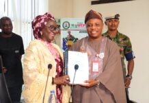 Permanent Secretary, Federal Ministry of Women Affairs, Dr Maryam Ismaila Keshinro receiving the Handing Over Notes from the former PS, FMWA, Amb. Gabriel Aduda during the ceremony held at the Ministry's Hqtrs in Abuja yesterday