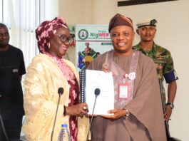 Permanent Secretary, Federal Ministry of Women Affairs, Dr Maryam Ismaila Keshinro receiving the Handing Over Notes from the former PS, FMWA, Amb. Gabriel Aduda during the ceremony held at the Ministry's Hqtrs in Abuja yesterday