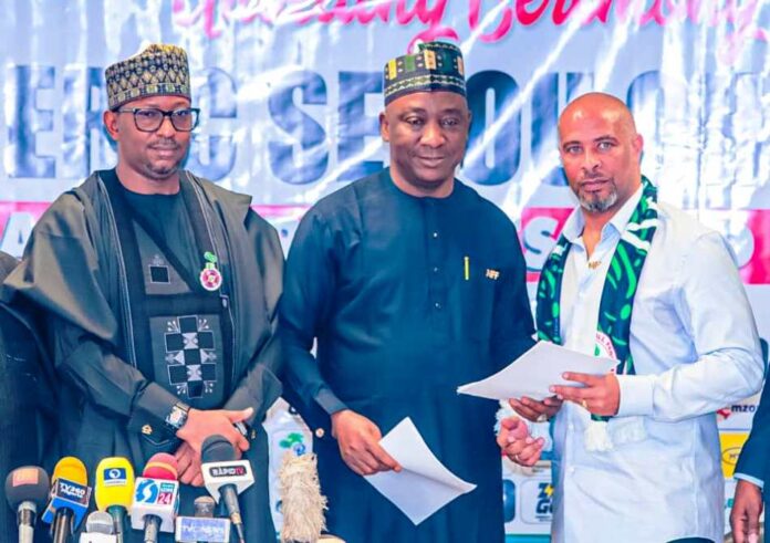 (L-r) NSC Chairman Mallam Shehu Dikko, NFF President Alhaji Ibrahim Gusau and Super Eagles chief coach Eric Sekou Chelle at Chelle's unveiling as Eagle's helmsman on Monday.