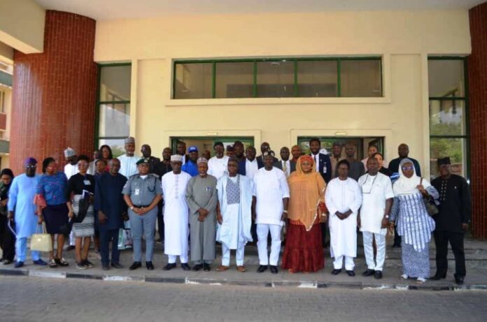 7th Right: Chairman RMAFC, Dr. M. B. Shehu OFR; DG NASRDA, Dr. Matthew Olumide Adepoju; 8th Right, Fed Commissioner Representing Bauchi State, Engr. Muhammed Sani Baba; 9th Right, Fed Commissioner Representing Kwara State, Hon. Ismaila Agaka, 6th Right, DG NASRDA, Dr. Matthew Olumide Adepoju; 5th Right, Federal Commissioner Representing Kebbi State, Barr. Rakiya A. T. Haruna mni; 4th Right, Federal Commissioner Representing FCT, Amb. Ayuba Nbako; 3rd Right, Federal Commissioner Representing Bayelsa State, Barr. Alfred Egba, and others.