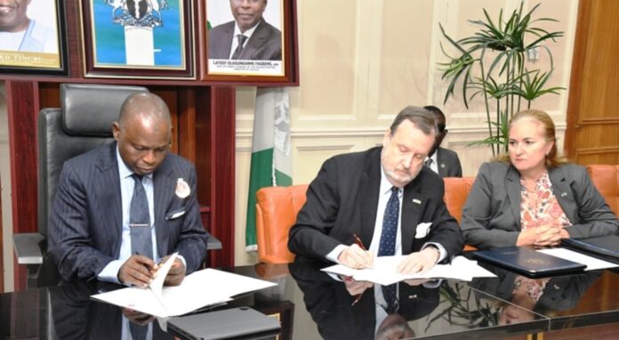 Hon. Attorney General of the Federation and Minister of Justice Lateef Fagbemi, SAN, and America Ambassador in Nigeria Richard Mills Jr., Signing Asset Return Agreement Between the Governments of Federal Republic of Nigeria and the United States of America at the Minister's Conference Room