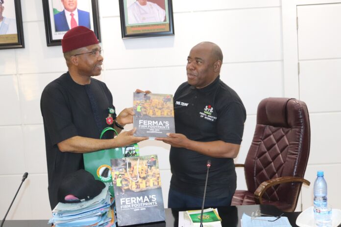 L-R, Managing Director/CEO, FERMA, Dr. Emeka Agbasi, FNSE, presenting one of FERMA’s publications (FERMA’s Firm Footprints) to the Perm. Sec. Federal Ministry of Works, Engr. Adebiyi Olusesan Olufunso, during the Perm. Sec’s interactive session with the MD/CEO, Directors and Heads of Units of the FERMA on Thursday 16th January, 2025