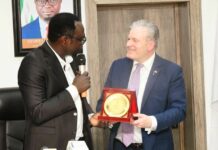 The Hon. Minister, Federal Ministry of Youth Development, Comrade Ayodele Olawande receiving a plaque from the President of IHK Giessen-Friedberg Chambers of Commerce, Dr. Matthias Leder, in his office.