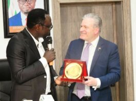The Hon. Minister, Federal Ministry of Youth Development, Comrade Ayodele Olawande receiving a plaque from the President of IHK Giessen-Friedberg Chambers of Commerce, Dr. Matthias Leder, in his office.