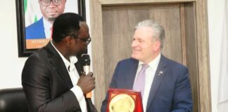 The Hon. Minister, Federal Ministry of Youth Development, Comrade Ayodele Olawande receiving a plaque from the President of IHK Giessen-Friedberg Chambers of Commerce, Dr. Matthias Leder, in his office.