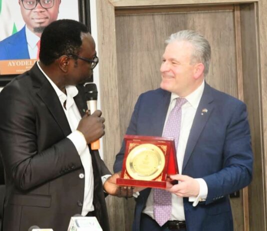 The Hon. Minister, Federal Ministry of Youth Development, Comrade Ayodele Olawande receiving a plaque from the President of IHK Giessen-Friedberg Chambers of Commerce, Dr. Matthias Leder, in his office.