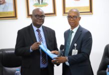 L-R: Permanent Secretary, Ministry of Police Affairs, Dr. Anuma Ogbonnaya Nila receiving hand over note from the Director overseeing the office of the Permanent Secretary, Mr. Okehie Isaac Tochukwu during a meeting with the Management and staff of the Ministry on his assumption of duty at the Ministry of Police Affairs Headquarters in Abuja