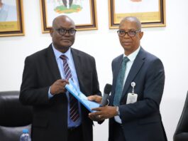 L-R: Permanent Secretary, Ministry of Police Affairs, Dr. Anuma Ogbonnaya Nila receiving hand over note from the Director overseeing the office of the Permanent Secretary, Mr. Okehie Isaac Tochukwu during a meeting with the Management and staff of the Ministry on his assumption of duty at the Ministry of Police Affairs Headquarters in Abuja
