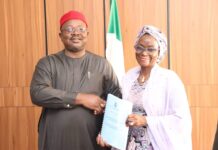 L-Dr. Onwusoro Maduka Ihemelandu, with Dr. Maryam Ismaila Keshinro-R, performing handover ceremony with a hanshake