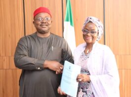 L-Dr. Onwusoro Maduka Ihemelandu, with Dr. Maryam Ismaila Keshinro-R, performing handover ceremony with a hanshake