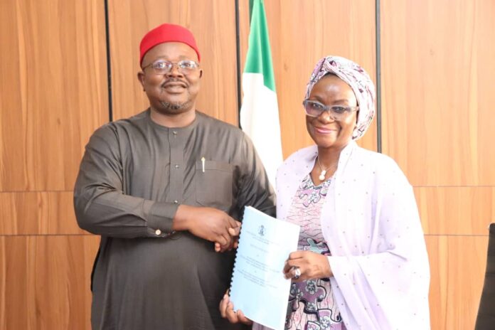 L-Dr. Onwusoro Maduka Ihemelandu, with Dr. Maryam Ismaila Keshinro-R, performing handover ceremony with a hanshake