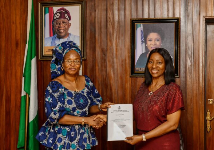 (L-R), Permanent Secretary, Service Welfare Office, Mrs Patience Oyekunle Nwakuso receiving the handing over notes from the former Director, Overseeing the office, Dr Comfort Adeosun.