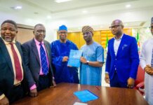 Dr. Iziaq Adekunle Salako Honourable Minister of State for Health & Social Welfare holding and displaying the signed MoU document with the Executive Governor of Edo State Senator Monday Okpebolo. 2nd Left: Barrister Tobi Omosa, Director, Legal Service Department in the Federal Ministry of Health & Social Welfare.